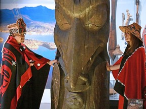 Sim'oogit Ni'isjoohl (Chief Earl Stephens) and Noxs Ts'aawit (Amy Parent) stand with the Ni'isjoohl memorial pole in the National Museum of Scotland on August 22, 2022.