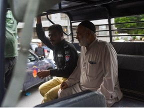 A police personnel arrests a supporter of Pakistan's former prime minister Imran Khan, during a protest in Karachi on August 5, 2023.