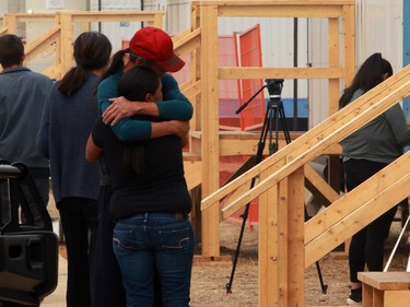 People share a moment at the Tselletkwe Lodge, a safe place for Indigenous evacuees and others who've been displaced due to the wildfires in Kamloops, B.C., Tuesday, Aug. 22, 2023.