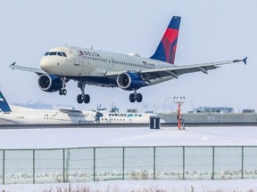 A Delta Airlines jet lands at the Calgary International Airport on Monday, March 6, 2023.