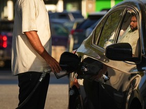 File photo: A motorist fuels up a vehicle at a Shell gas station in Vancouver on October 1, 2022.