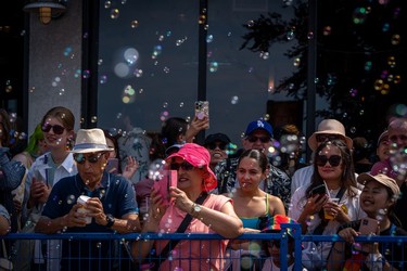 Bubbles are blown at people during the Pride Parade at English Bay in Vancouver, B.C., Sunday, Aug. 6, 2023.