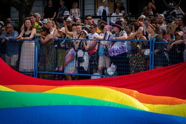 A large flag passes by during the Pride Parade at English Bay in Vancouver, B.C., Sunday, Aug. 6, 2023.