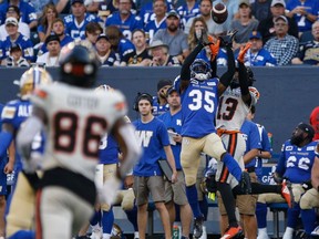 Winnipeg Blue Bombers' Demerio Houston intercepts the pass intended for B.C. Lions' Alexander Hollins (13) during first half CFL action in Winnipeg Thursday, August 3, 2023.