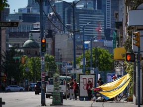 An outreach team for the Union Gospel Mission in Vancouver has been working in the city's Downtown Eastside to ensure people are aware and are prepared to cope with the latest heat spike across parts of B.C. A tarp is seen draped between a building and a shopping cart to provide shade from the sun in the Downtown Eastside of Vancouver, on Saturday, May 13, 2023.
