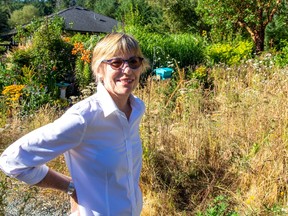 Galiano Island resident Jennifer Margison in front of her home among the natural, drought resistant landscaping she has installed.