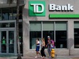 People walking past a Toronto-Dominion Bank in Miami Beach, Florida.