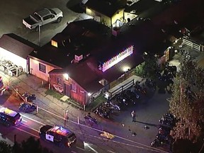 In an image from video, authorities work at the scene of a fatal shooting Wednesday, Aug. 23, 2023, at Cook's Corner, a biker bar in rural Trabuco Canyon, Calif., in Orange County. (ABC7 Los Angeles via AP)