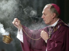 FILE - Bishop Howard Hubbard swings incense during an Ash Wednesday communion service at the Cathedral of the Immaculate Conception on Feb. 25, 2004, in Albany, N.Y. The 84-year-old retired bishop of Albany, who has been accused of sexual abuse and has unsuccessfully sought to be removed from the priesthood, said Tuesday, Aug. 1, 2024, he recently married a woman in a civil ceremony.