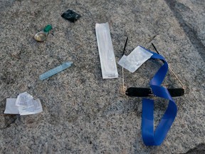 Items are seen on the ground as paramedics from B.C. Ambulance respond to a drug overdose in downtown Vancouver, Wednesday, June 23, 2021. British Columbia is on pace for the deadliest year in its unregulated toxic-drug crisis, with the BC Coroners Service saying another 198 deaths were reported in July.