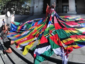 Jaylene Tyme, a two-spirited Indigenous activist, poses in the Amsterdam Rainbow Dress at the Vancouver Art Gallery in Vancouver B.C. on August 4 , 2023.