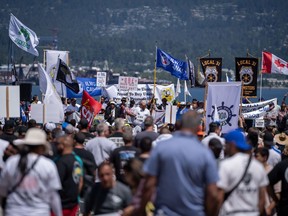 Workers attend a strike rally in Vancouver on Sunday, July 9, 2023. Workers in the ongoing British Columbia port dispute are taking a full-union vote to determine if the latest deal recommended by negotiators is acceptable, with the possible end to the months-long conflict in the balance.