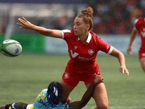 Canada's Chloe Daniels passes the ball away before being pulled down by St. Lucia's Renetta Fredericks during women's semi-final rugby action at the Rugby Sevens Paris 2024 Olympic qualification event at Starlight Stadium in Langford, B.C., Sunday, Aug. 20, 2023.
