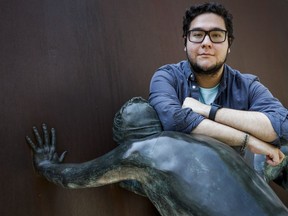 Luis Sanchez Diaz, an international student from Mexico studying at the University of Calgary, leans on a statue on campus in Calgary, Wednesday, Aug. 23, 2023.