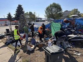 Volunteers seen dismantling structures at the Millennium Park encampment on Sept. 8.