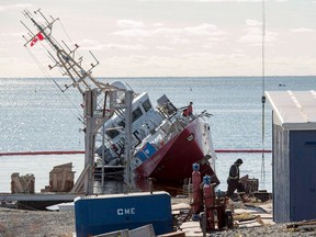 The Canadian Coast Guard patrol ship, CCGS Corporal McLaren, is shown on its side, partially submerged after it was released from its cradle and slid down a ramp in a Sambro Head, N.S. shipyard. The nearly new ship suffered $14 million in damage.