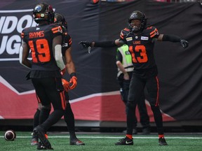 B.C. Lions' Alexander Hollins (13), and Dominique Rhymes celebrate a touchdown against the Saskatchewan Roughriders in July.