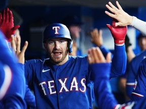 Texas Rangers' Robbie Grossman celebrates his two-run home run against the Blue Jays during the fifth inning in Toronto on Wednesday, Sept. 13, 2023.