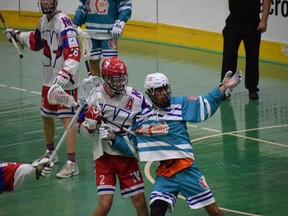New Westminster Salmonbellies defender Brett Mydske tussles with a Six Nations Chiefs player during New Westminster's 11-10 win in Game 4 of the Mann Cup Tuesday night at Queen's Park Arena. Game 5 is this evening.