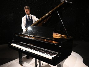 Freddie Mercury's Yamaha G-2 baby grand piano, is pictured during a press preview ahead of the "Freddie Mercury: A World of His Own" auctions at Sotheby's auctioneers in London.