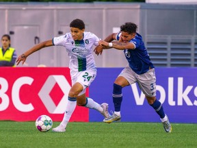 York United's Osaze De Rosario holds off Wanderers defender Zachary Tognon Fernandez during a Canadian Championship game in May. De Rosario returns to the York lineup after a month off because of a suspension to unintentional Cannabis use, as the Nine Stripes push for the CPL playoffs