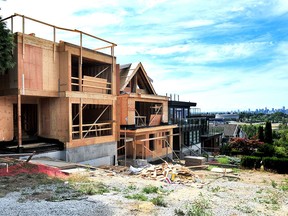 Single-family homes are seen under construction in Vancouver on July 31, 2023. Although the city will now allow the construction of multiplexes, the zoning reforms have been designed in such a manner that very few will likely be built, writes Adam Zivo.