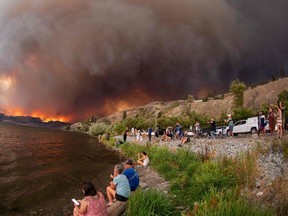 Residents watch the McDougall Creek wildfire in West Kelowna on Aug. 17 from Kelowna.