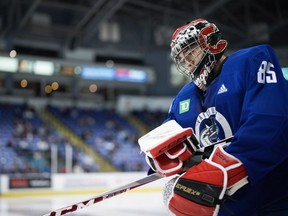 Vancouver Canucks goalie Ty Young skates back to the net after taking a break during the opening day of the NHL hockey team's training camp, in Victoria, Thursday, Sept. 21, 2023.