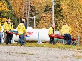 Prince George Search and Rescue crews prepare their gear in a staging area at Purden Lake Resort near the site of a helicopter crash, east of Prince George, B.C., on Tuesday, Sept. 26, 2023.