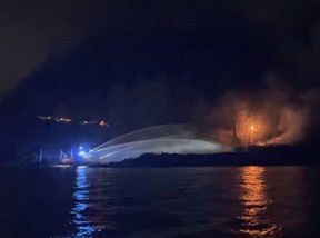 A Vancouver fire boat and West Vancouver fire crews fight a blaze at a vacant house at 6689 Nelson Ave. in West Vancouver the night of Sept. 22-23. Still from a video provided by the West Vancouver Fire Department.