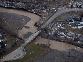 A collapsed section of bridge destroyed by severe flooding is seen in Merritt, B.C., in an aerial view from a Canadian Forces reconnaissance flight on Monday, Nov. 22, 2021. Officials with the British Columbia government and the City of Merritt were aware of significant problems with dikes for several years before a series of atmospheric rivers flooded the community, documents released through a freedom of information request show.