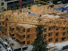 Canada's national housing agency has warned millions of homes need to be built within a span of years to balance the housing market, but even it seems doubtful that its own target is achievable. A construction worker is seen on top of a low-rise condo development being built in Coquitlam, B.C., on Tuesday, May 16, 2023.