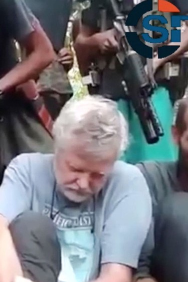 The Abu Sayyaf terrorist group released a video Tuesday demanding more than $100-million for the release of four hostages, including two Canadians, who were kidnapped from a resort in the southern Philippines in September. The 90-second video obtained by the SITE Intelligence Group showed black-clad gunmen standing over Canadians John Ridsdel and Robert Hall, as well Hall's girlfriend Marites Flor and Norwegian Kjartan Sekkingstad.