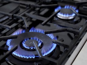 British Columbia natural gas users will soon see their bills decrease starting in October. Flames emerge from burners on a natural gas stove, Wednesday, June 21, 2023, in Walpole, Mass.