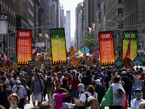 FILE - Climate activists march on Madison Avenue while protesting energy policy and the use of fossil fuels, in New York, Sunday, Sept. 17, 2023. Outside the gates of the United Nations, many civil society groups, activists and major philanthropic foundations are making plans on the sidelines of the General Assembly to push forward toward achieving the Sustainable Development Goals.