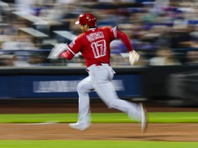 Los Angeles Angels' Shohei Ohtani (17), of Japan, advances to third base on a sacrifice fly by Brandon Drury during the third inning of the team's baseball game against the New York Mets, Friday, Aug. 25, 2023, in New York.