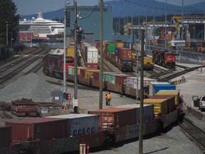 A CN Rail train moves cargo containers at the Centerm Container Terminal at port in Vancouver, on Friday, July 14, 2023.The Vancouver Fraser Port Authority says container shipments are falling fast, as consumer demand weakens amid a sputtering economy.