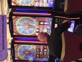 A gambler plays a slot machine at the Hard Rock casino in Atlantic City, N.J., on May 17, 2023. Commercial casinos in the U.S. had their best July ever this year, winning nearly $5.4 billion from gamblers, according to figures released on Sept. 14, 2023, by a national gambling industry group.