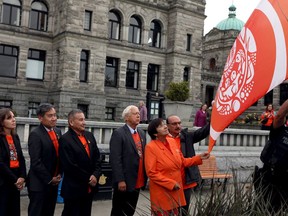BC Green party Leader Sonia Furstenau, (left to right) BC United MLA Michael Lee, Grand Chief Stewart Phillip, Minister of Indigenous Relations and Reconciliation Murray Rankin, MLA Joan Phillips and MLA Raj Chouhan raise the Survivors' Flag to honour the hundreds of children who never returned home from residential schools, during a ceremony at the legislature in Victoria, B.C., on Monday, Sept. 25, 2023.