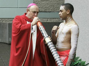 FILE - Bishop Christopher Saunders of Broome tries to play a digeridoo during a World Youth Day 2008 media event in Sydney, Australia, on April 17, 2008. The Vatican is considering the findings of a church investigation into "very serious and deeply distressing" child sexual abuse allegations against former Australian Bishop Saunders, a church leader said on Tuesday, Sept. 19, 2023.