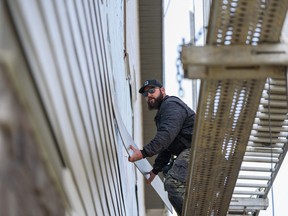 Vinyl siding damaged by a hail storm in Calgary is being replaced with more expensive but more hail-resistant fibre cement siding.