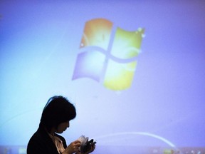 The Microsoft logo appears on screen prior a meeting in Beijing on December 3, 2014.