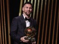 Inter Miami CF's Argentine forward Lionel Messi reacts on stage with his trophy as he receives his 8th Ballon d'Or award.