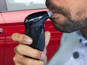 A man blows into a roadside tester.