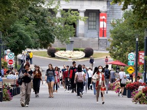 McGill University students walk toward Sherbrooke Street and the Roddick Gates in Montreal, on Wednesday, September 22, 2021. (