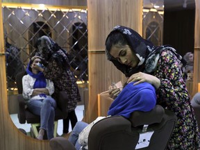 Sultana Karimi applies makeup on a customer at Ms. Sadat’s Beauty Salon in Kabul, Afghanistan, Sunday, April 25, 2021. Kabul's young working women say they fear their dreams may be short-lived if the Taliban return to Kabul, even if peacefully as part of a new government.