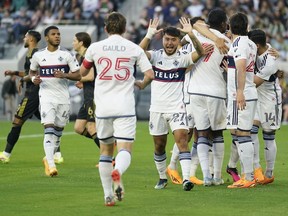 Vancouver Whitecaps players celebrate after defender Ranko Veselinovic scored two minutes into their game against LAFC at BMO Stadium in Los Angeles in June.