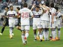 Vancouver Whitecaps players celebrate after defender Ranko Veselinovic scored two minutes into their game against LAFC at BMO Stadium in Los Angeles in June.
