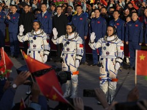 Chinese astronauts for the Shenzhou-17 mission, from left, Jiang Xinlin, Tang Hongbo and Tang Shengjie, wave as they attend a send-off ceremony for their manned space mission at the Jiuquan Satellite Launch Centre in northwestern China on Thursday.