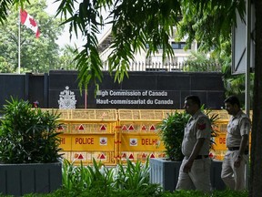 Security personnel stand guard in front of the High Commission of Canada in New Delhi on Sept. 19, 2023.